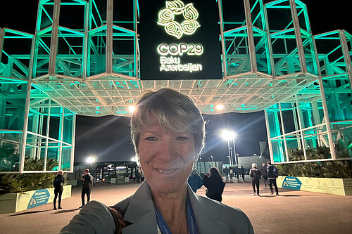 Photo showing Pippa Heylings MP outside COP29 in Baku, Azerbaijan